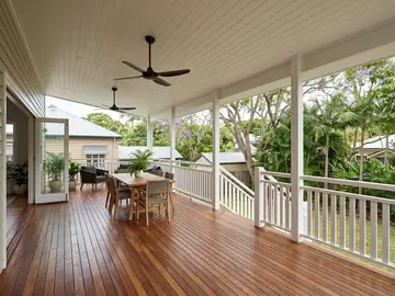 New rear deck in spotted gum with a white balustrade and ceiling fans